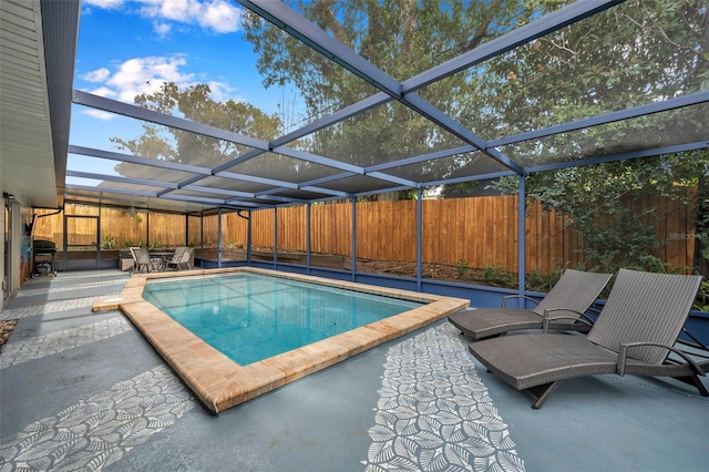 view of swimming pool featuring a lanai and a patio