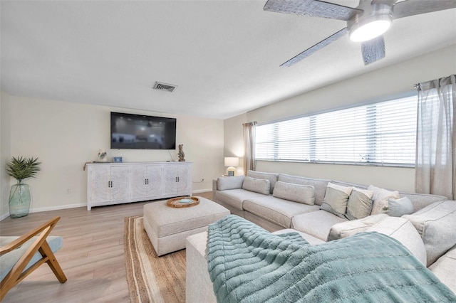 living room with light hardwood / wood-style flooring and ceiling fan