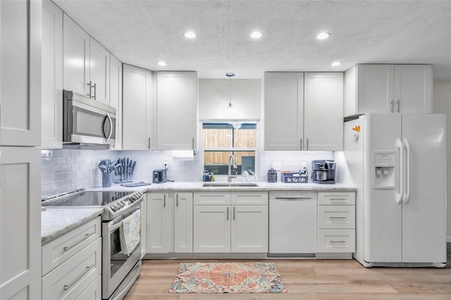 kitchen featuring sink, white cabinetry, and stainless steel appliances