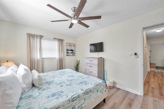 bedroom featuring ceiling fan and light hardwood / wood-style floors