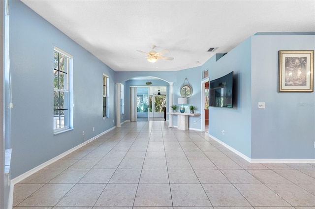 unfurnished living room featuring ceiling fan and light tile patterned floors