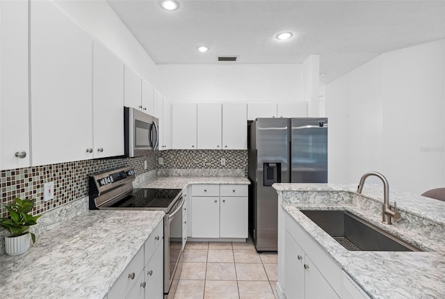 kitchen with white cabinetry, sink, and stainless steel appliances