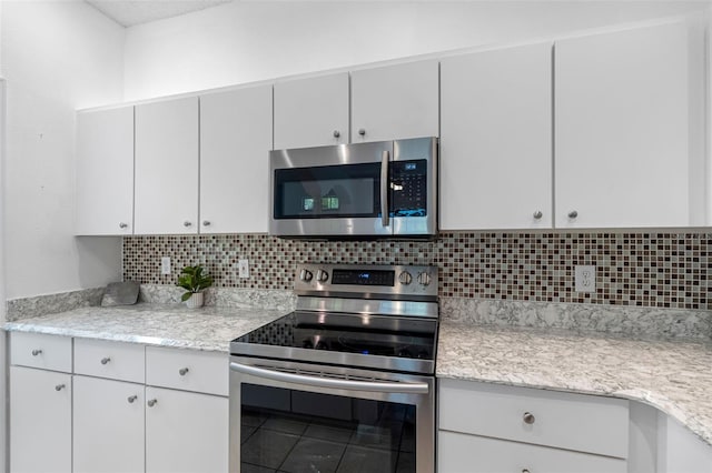 kitchen with white cabinetry, light stone countertops, decorative backsplash, and stainless steel appliances