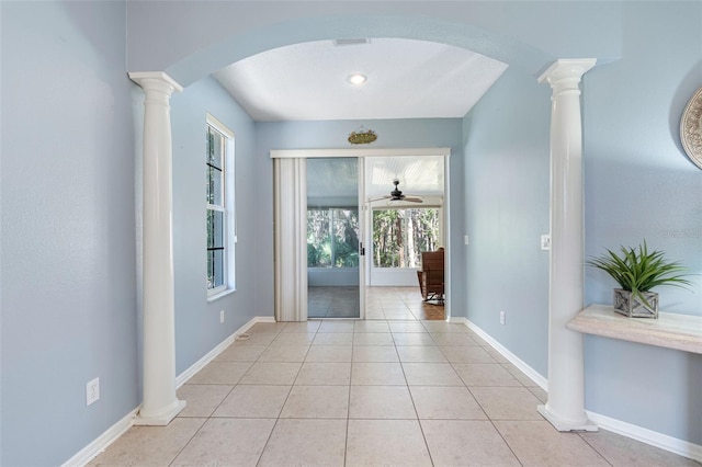 entrance foyer with light tile patterned floors, decorative columns, and ceiling fan