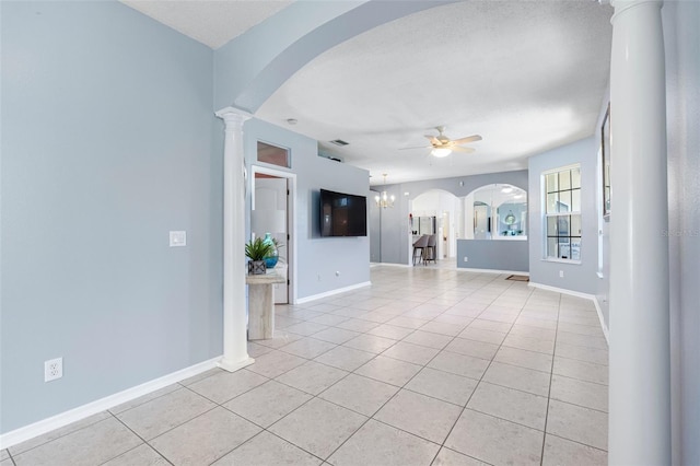 unfurnished living room with ceiling fan with notable chandelier, decorative columns, and light tile patterned floors