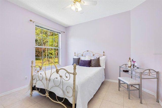 tiled bedroom featuring ceiling fan