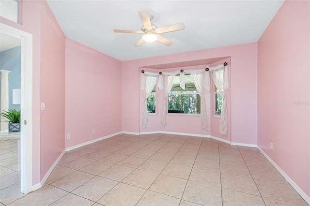 tiled spare room featuring ceiling fan