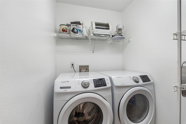 clothes washing area featuring laundry area and washing machine and dryer