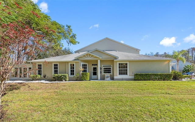 ranch-style house with stucco siding and a front yard