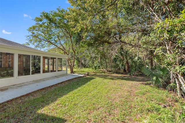 view of yard featuring a sunroom