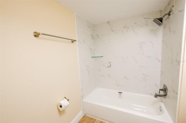 bathroom featuring tiled shower / bath combo and tile patterned floors