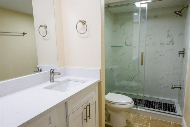 bathroom featuring tile patterned floors, vanity, toilet, and an enclosed shower