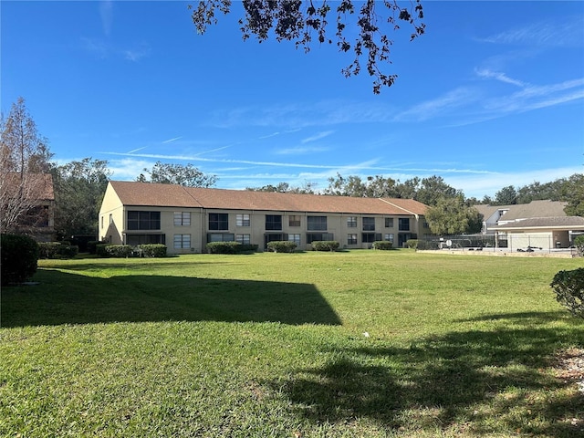 rear view of property featuring a yard