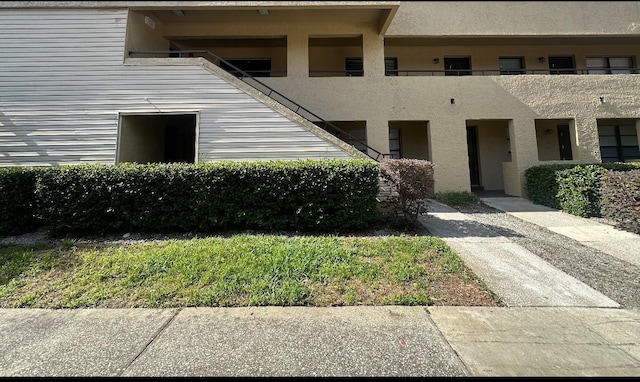 exterior space featuring a balcony and stucco siding