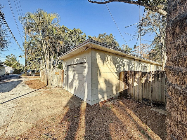 view of home's exterior with a garage and an outdoor structure