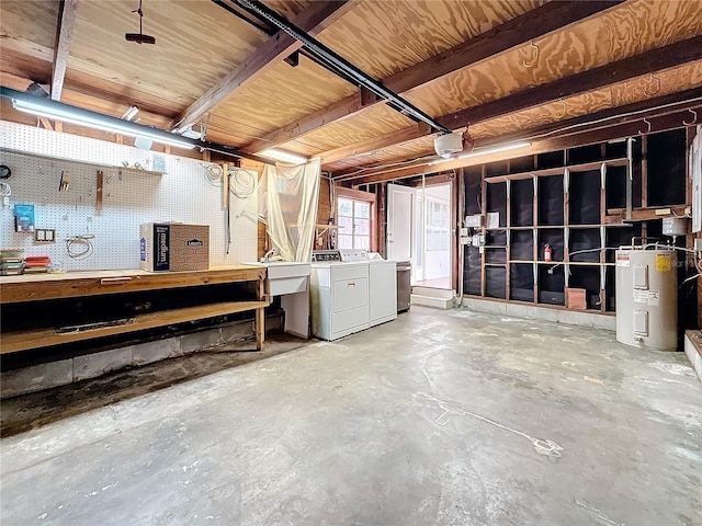 basement featuring sink, separate washer and dryer, electric water heater, and a workshop area