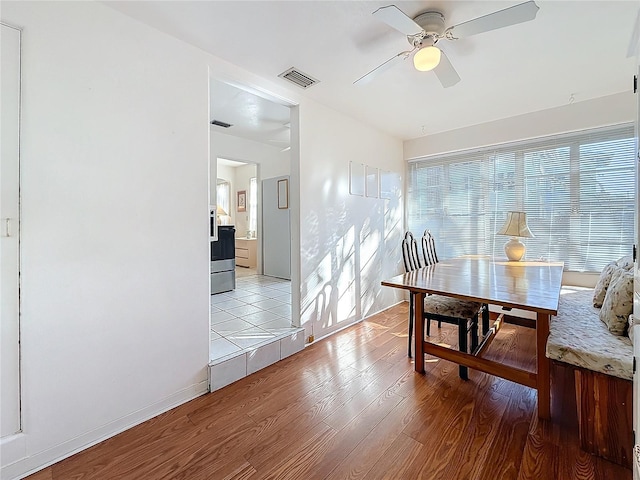 dining room with ceiling fan and light hardwood / wood-style floors