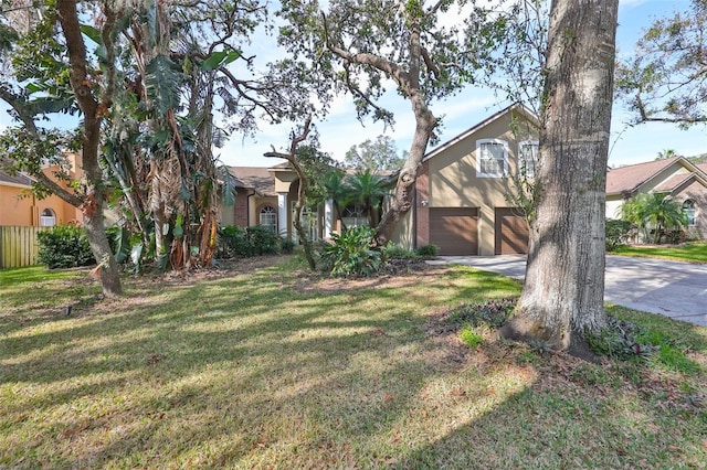 view of front of house featuring a garage and a front lawn