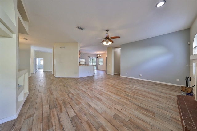 unfurnished living room featuring ceiling fan and light wood-type flooring