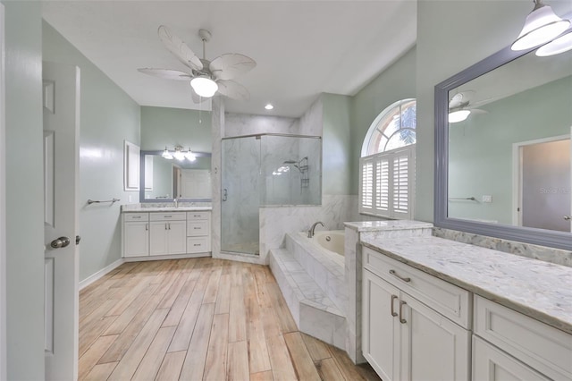 bathroom featuring vanity, separate shower and tub, and ceiling fan