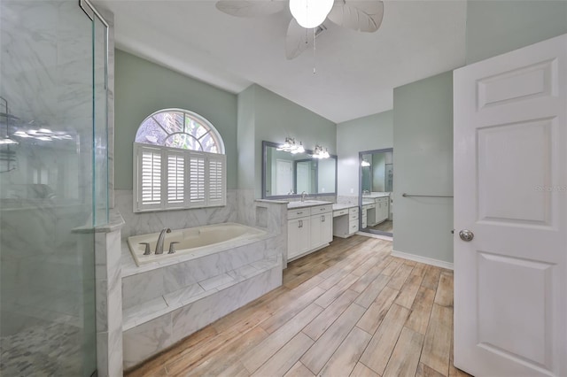 bathroom with hardwood / wood-style floors, vanity, ceiling fan, and independent shower and bath