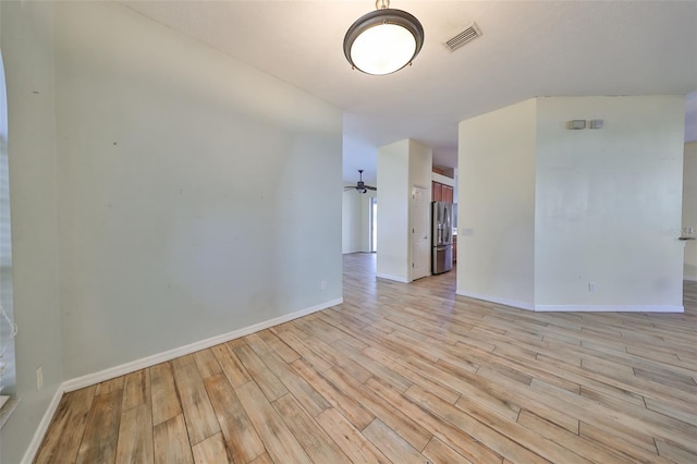 spare room with light wood-type flooring and ceiling fan