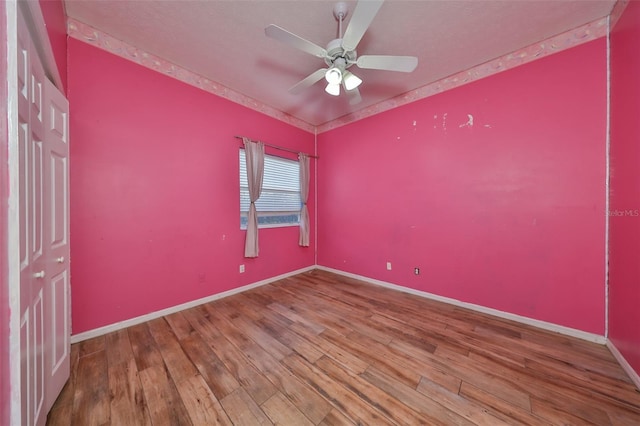 empty room featuring ceiling fan and wood-type flooring