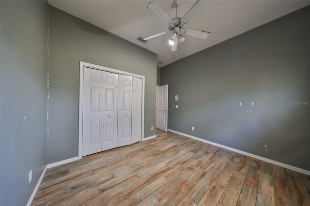 unfurnished bedroom featuring ceiling fan, a closet, and light hardwood / wood-style floors