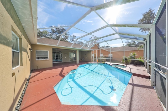 view of pool with a lanai, an in ground hot tub, and a patio