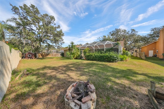 view of yard with a lanai and a storage shed