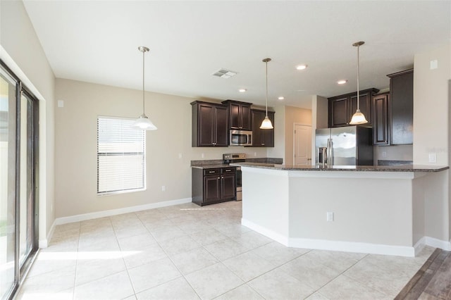 kitchen featuring decorative light fixtures, dark brown cabinetry, and stainless steel appliances