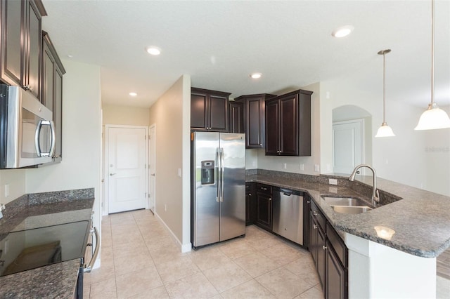 kitchen featuring sink, light tile patterned flooring, pendant lighting, and appliances with stainless steel finishes