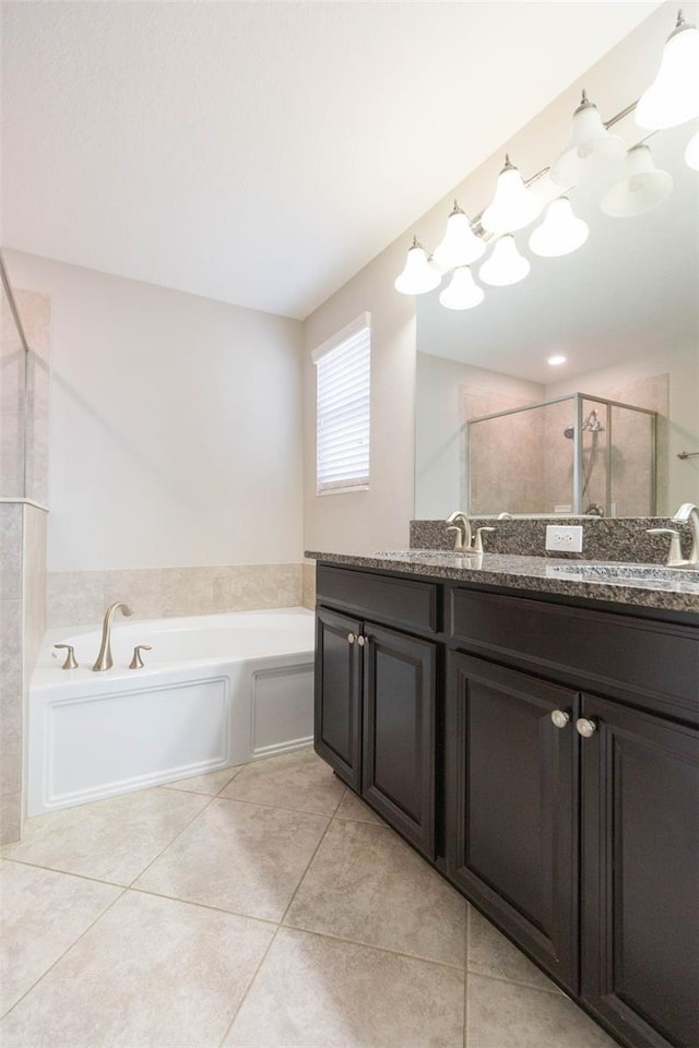 bathroom featuring tile patterned floors, vanity, and separate shower and tub