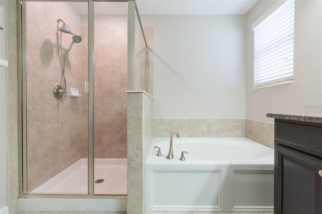 bathroom featuring plus walk in shower and vanity