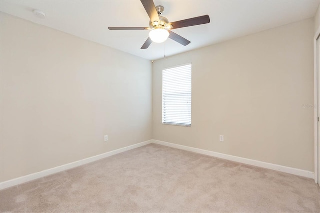 empty room with light carpet and ceiling fan