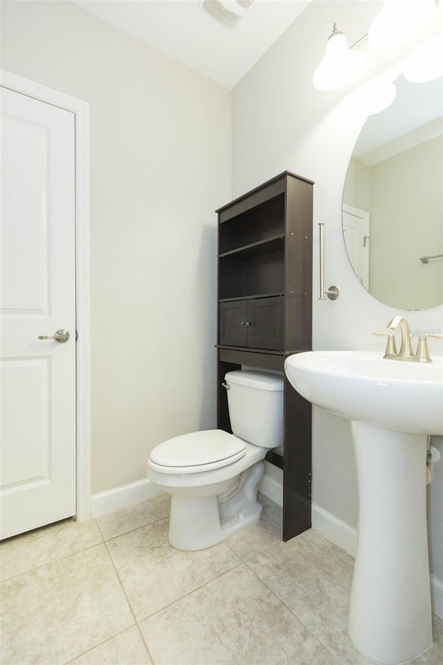 bathroom featuring tile patterned flooring and toilet