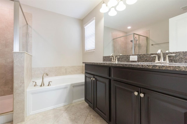 bathroom featuring shower with separate bathtub, vanity, and tile patterned floors