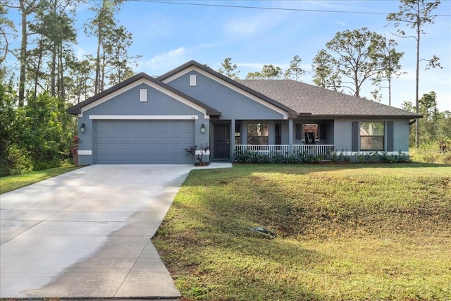 view of front of house featuring a front yard, a porch, and a garage