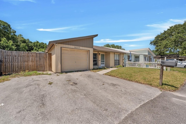 single story home with a front yard and a garage