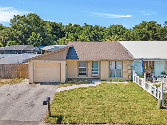 single story home featuring a front yard and a garage