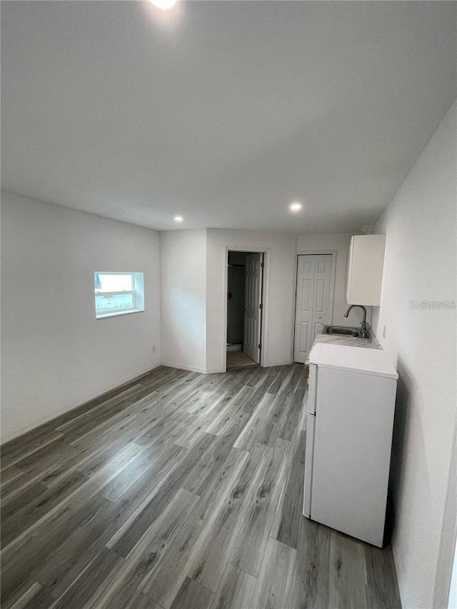 laundry area featuring washer / dryer, light hardwood / wood-style flooring, and sink