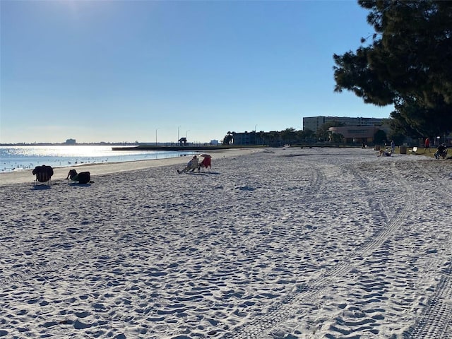 exterior space with a water view and a view of the beach