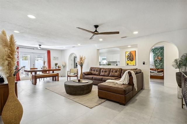 living room featuring french doors and ceiling fan