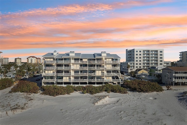 outdoor building at dusk with a water view and a beach view