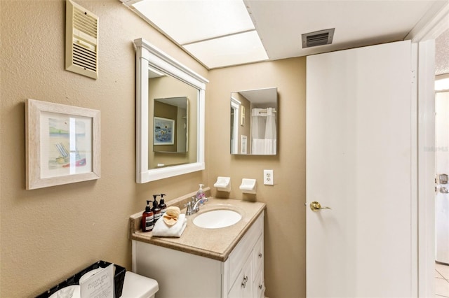 bathroom featuring toilet and vanity