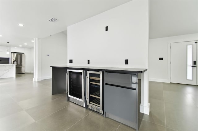 kitchen featuring high end fridge, beverage cooler, and fridge