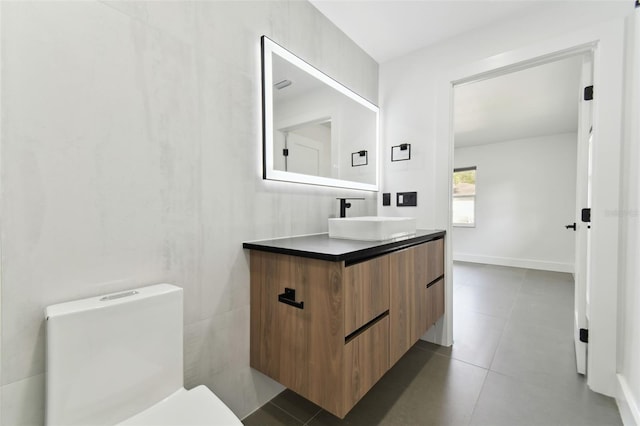 bathroom with tile patterned floors, vanity, and toilet