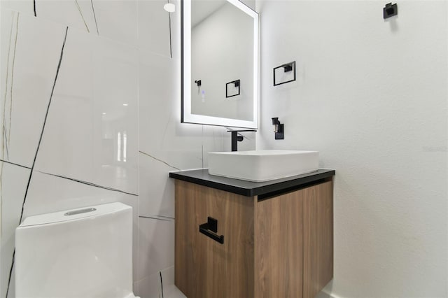 bathroom featuring vanity and toilet