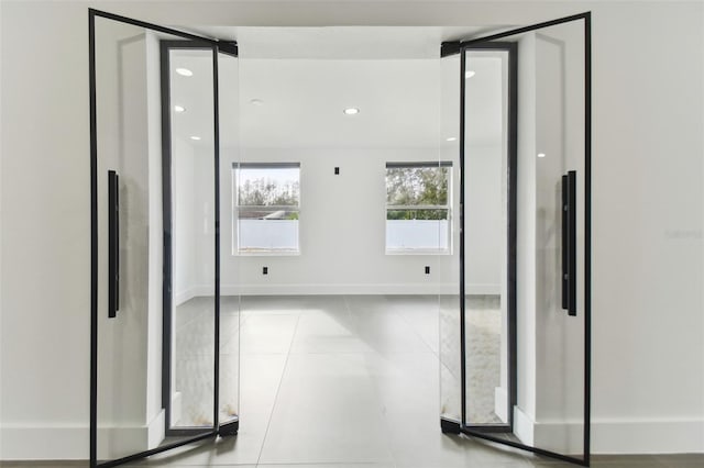 hallway featuring light tile patterned floors