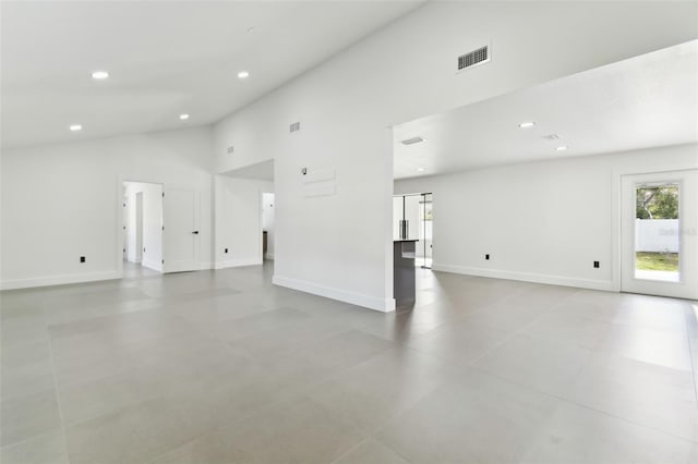 unfurnished living room featuring high vaulted ceiling and a healthy amount of sunlight